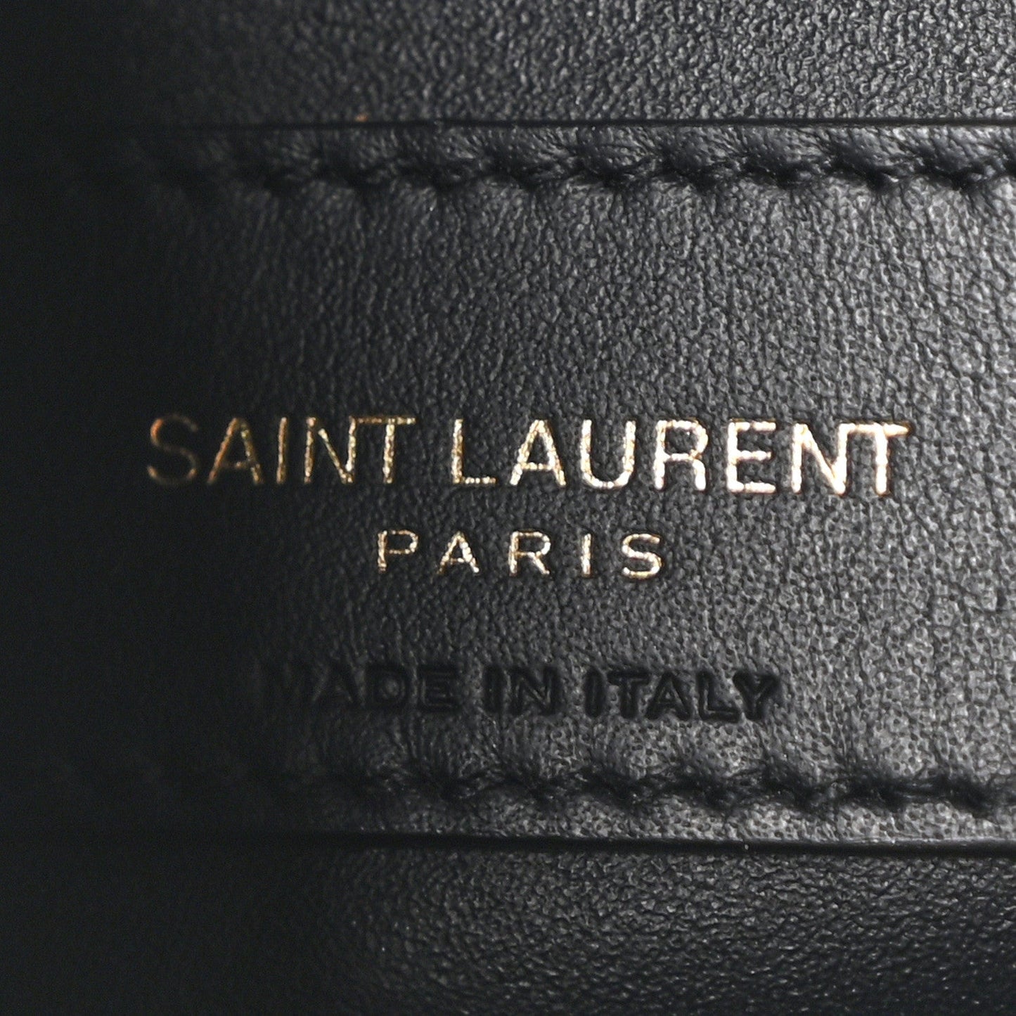 Black leather hobo bag label reading SAINT LAURENT PARIS