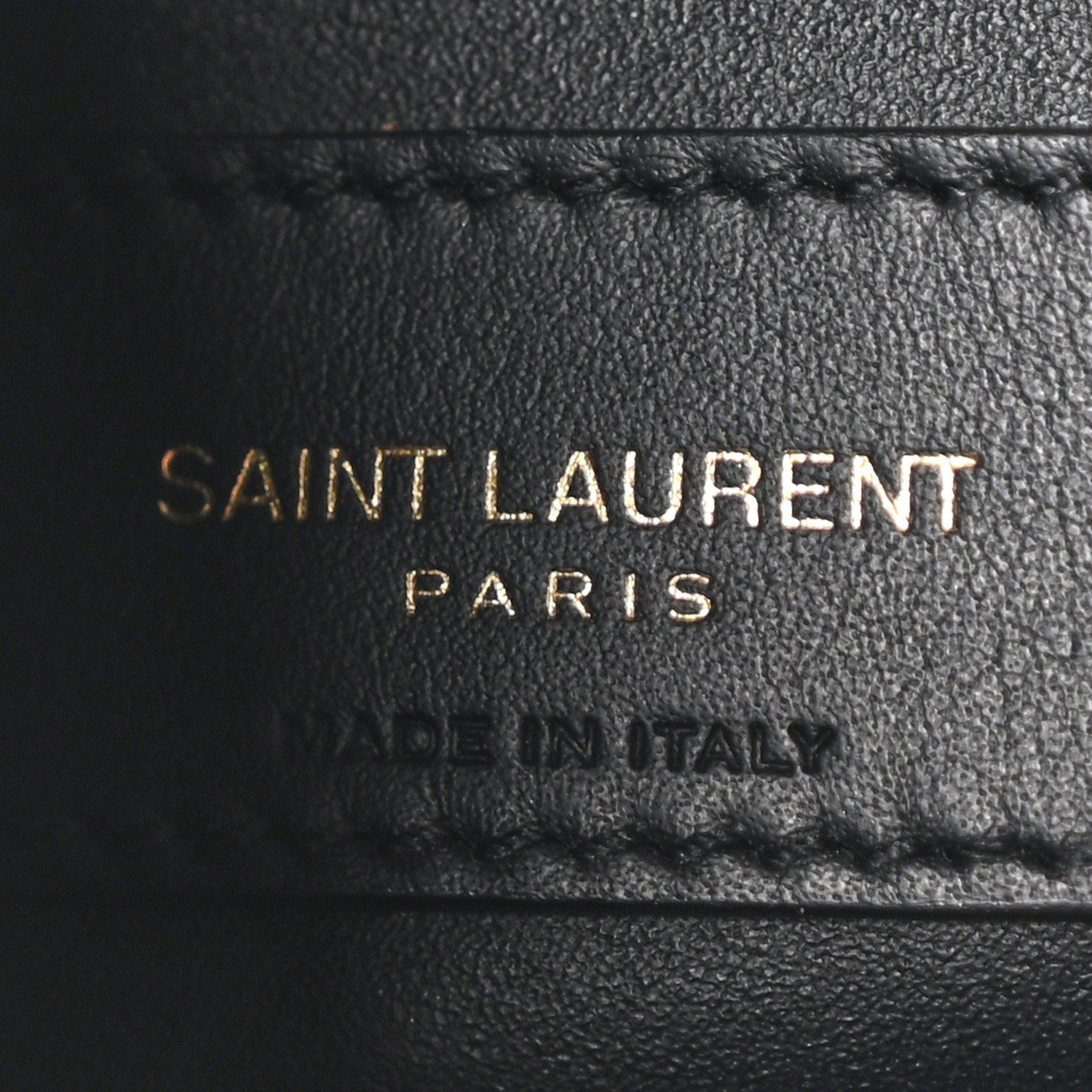 Black leather hobo bag label reading SAINT LAURENT PARIS