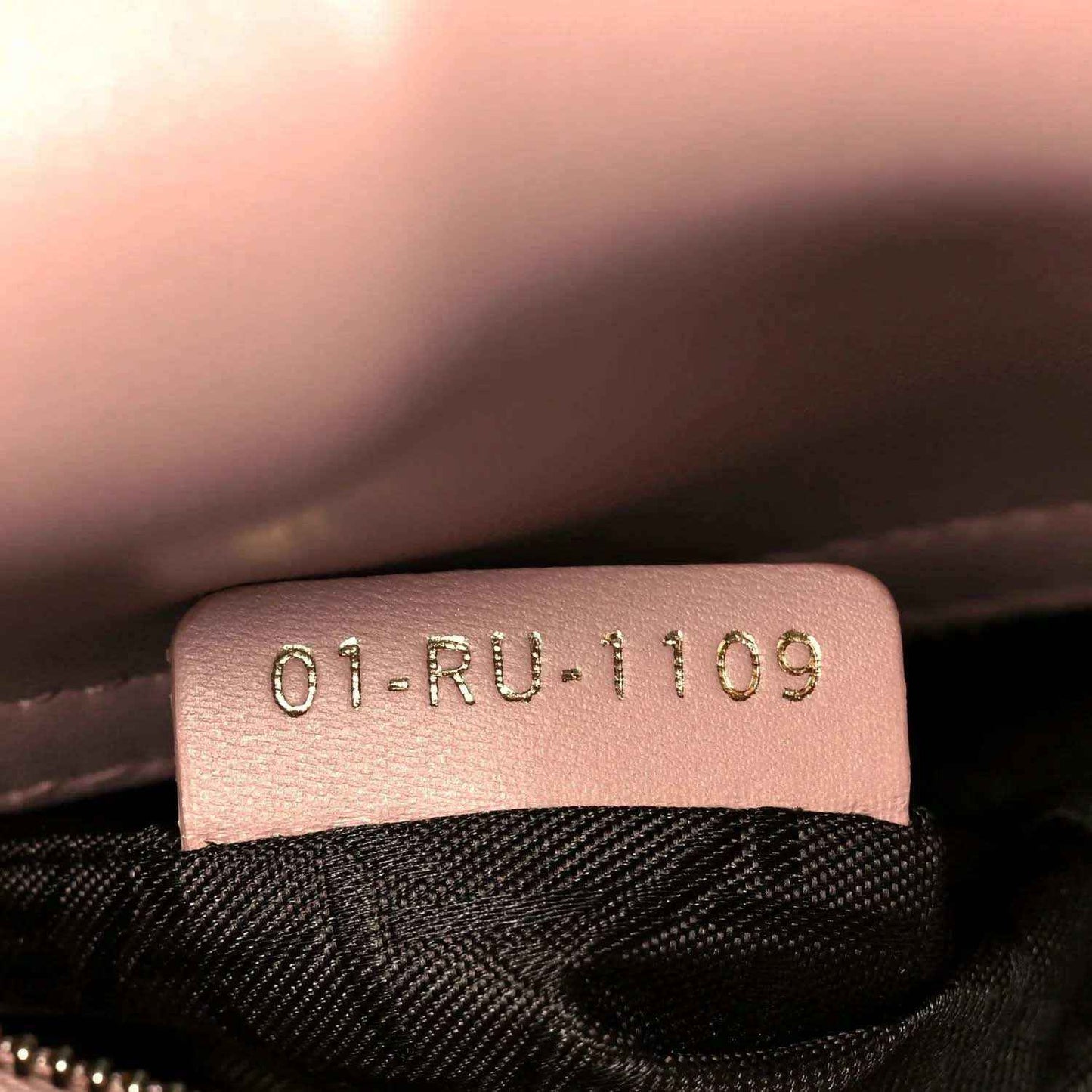Leather date code patch inside bag reading 01-RU-1109