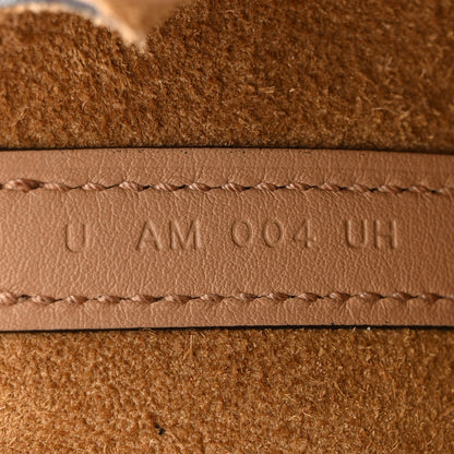Micro tote bag leather strap seam close-up with stamped marking
