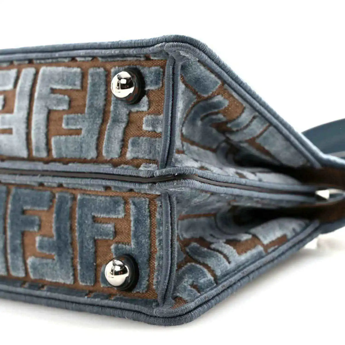 Satchel interior lining close-up with FF pattern, edge piping, and strap attachment