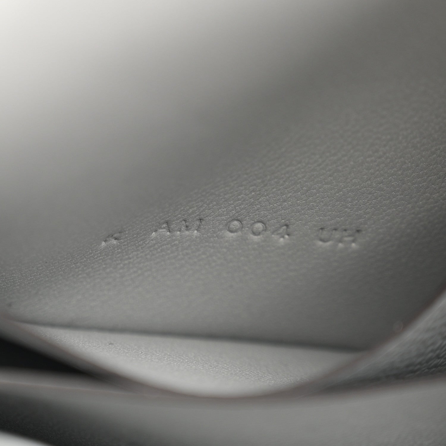 Hermes Constance slim wallet embossed markings on light blue leather interior.