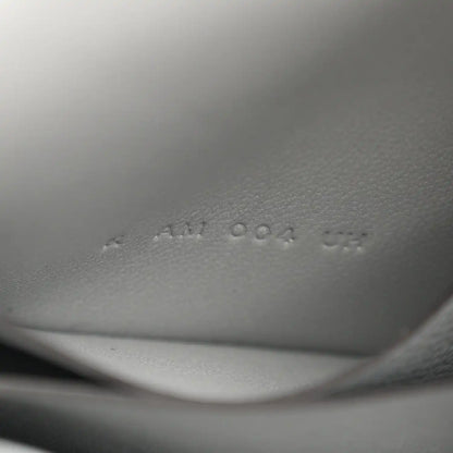 Hermes Constance slim wallet embossed markings on light blue leather interior.