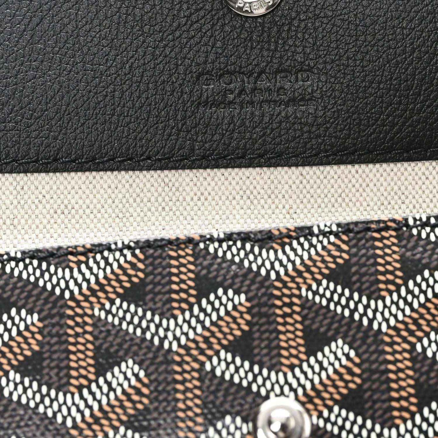 Goyardine tote corner detail with textured black leather trim and monogram canvas