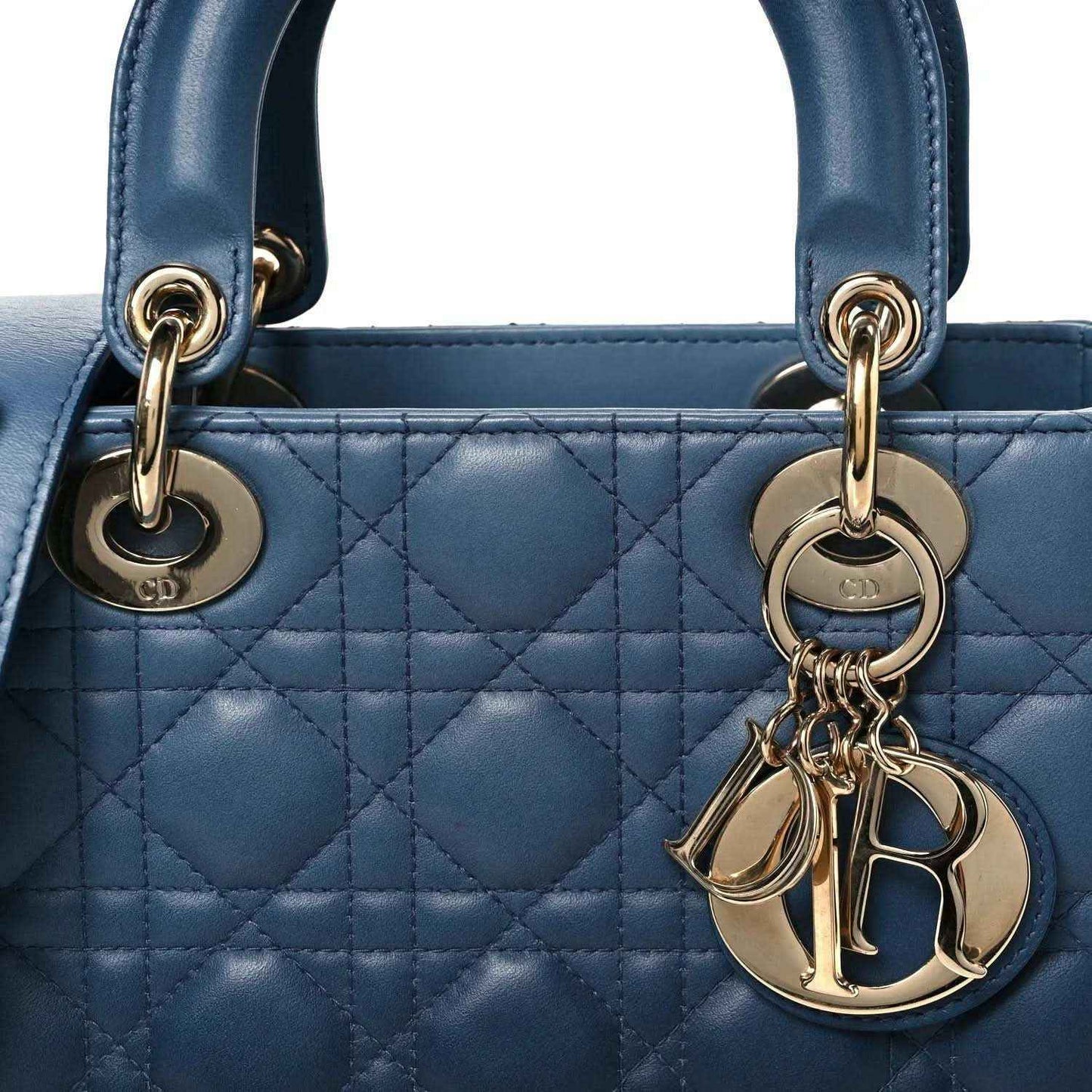 Indigo blue quilted leather handbag front with CD logo rings and Dior charm