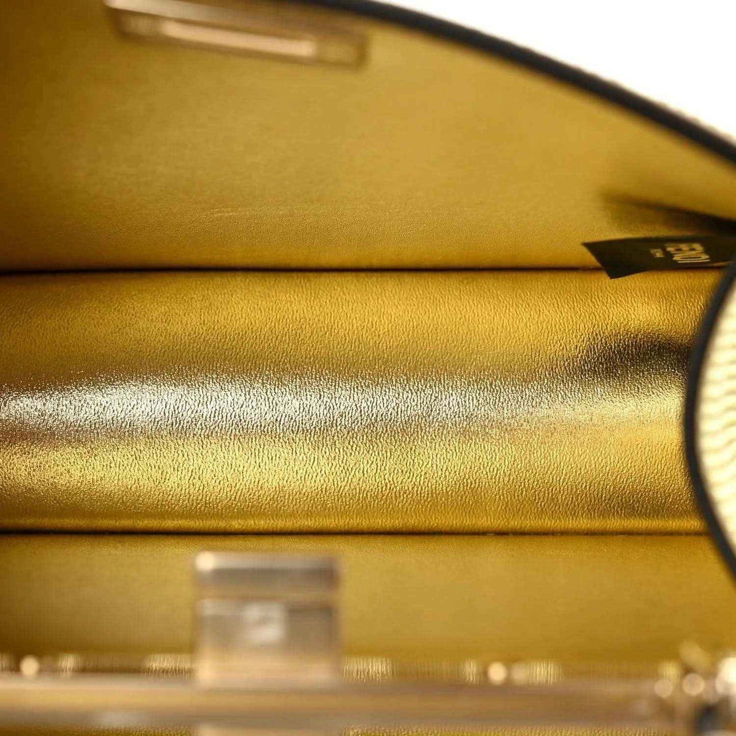 Gold interior lining with metal clasp hardware and curved top edge