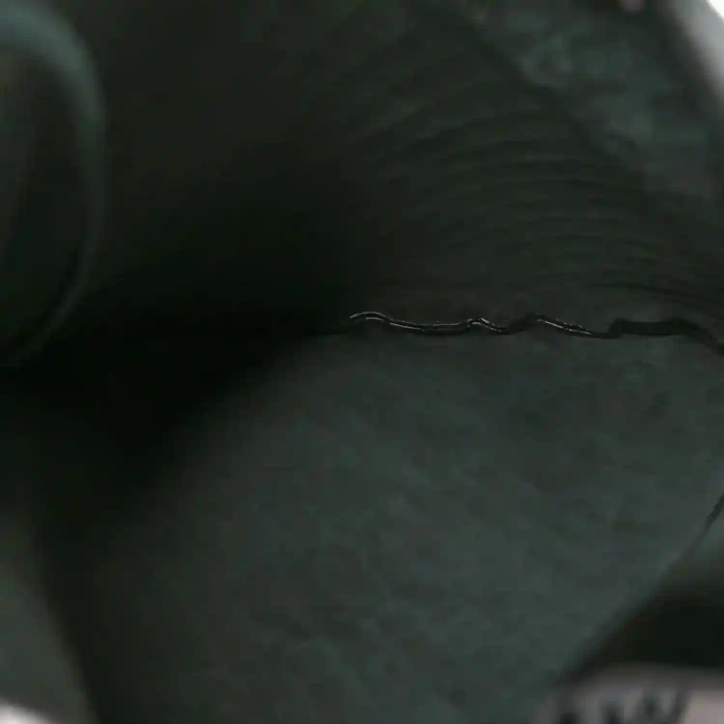 Dark green leather interior panel with stitched edge