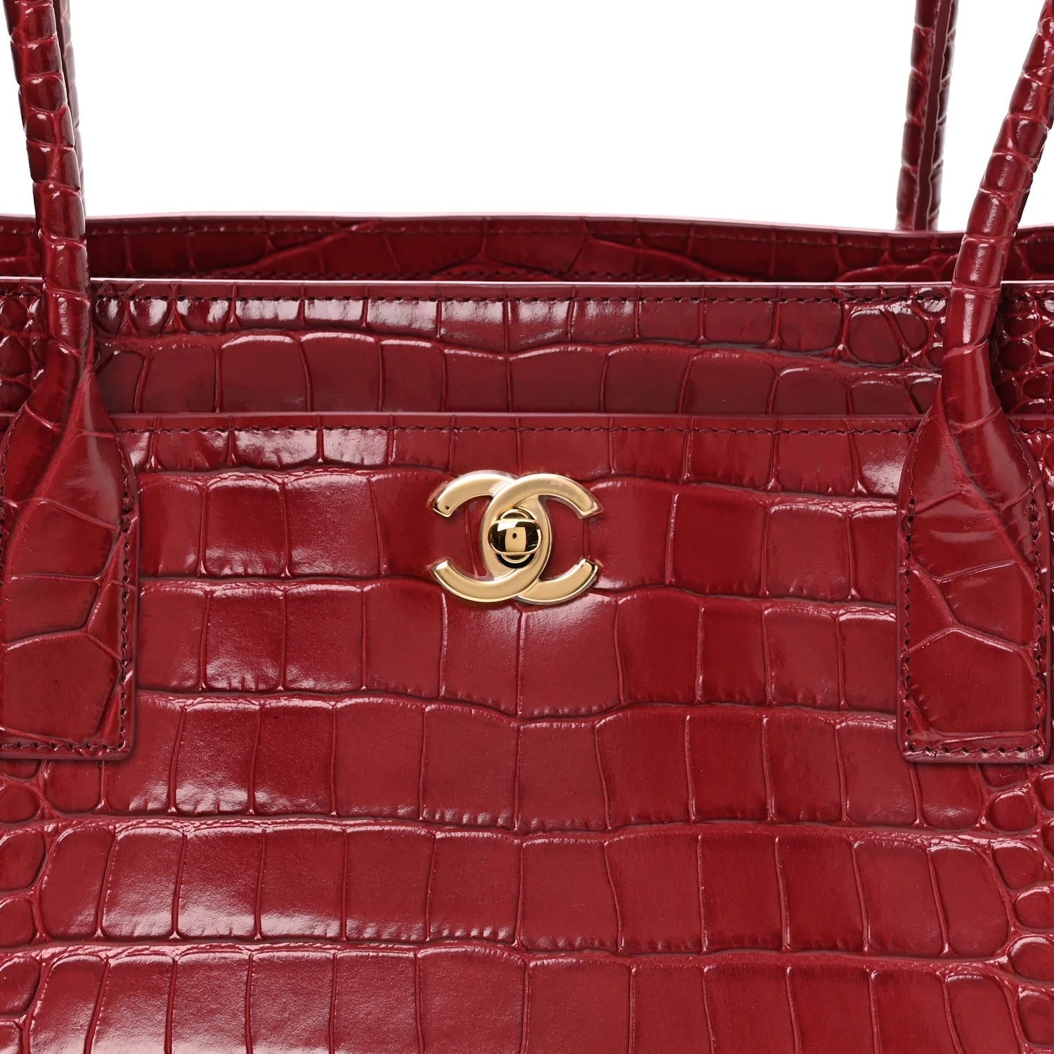 Small Chanel shopping bag front with croc-embossed texture and CC turn-lock in dark red