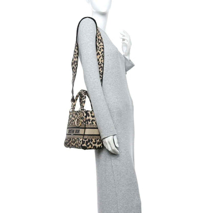 Christian Dior leopard canvas bag worn crossbody with adjustable strap