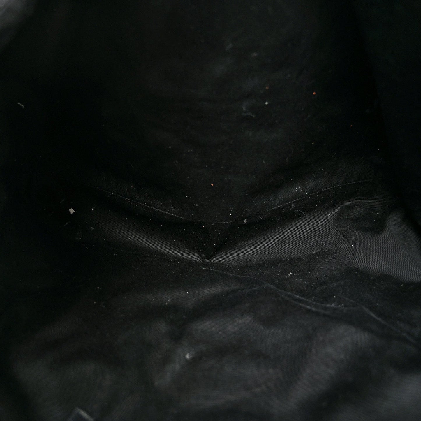 Close-up of black quilted leather texture with visible stitching
