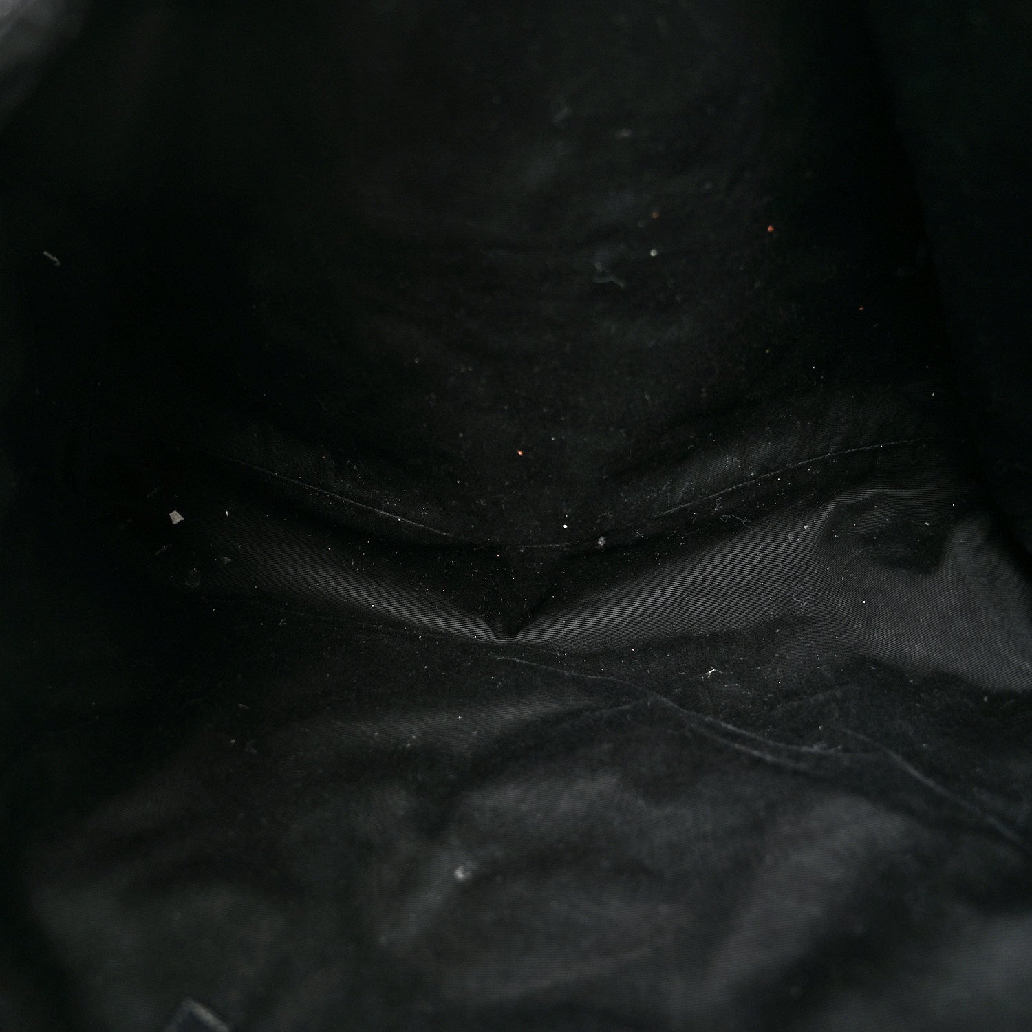 Close-up of black quilted leather texture with visible stitching