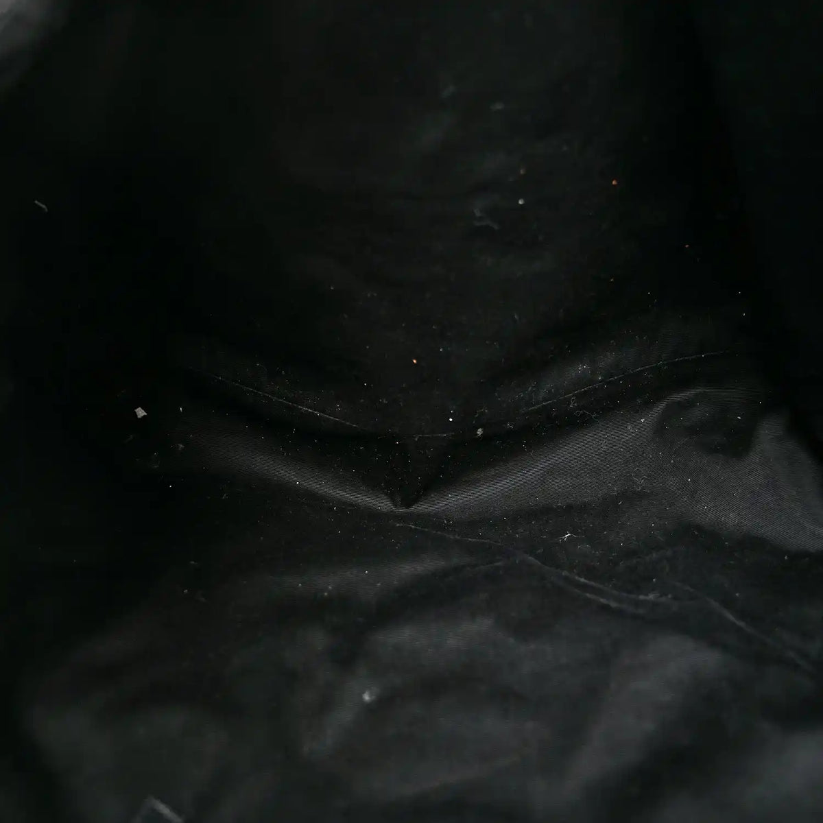 Close-up of black quilted leather texture with visible stitching
