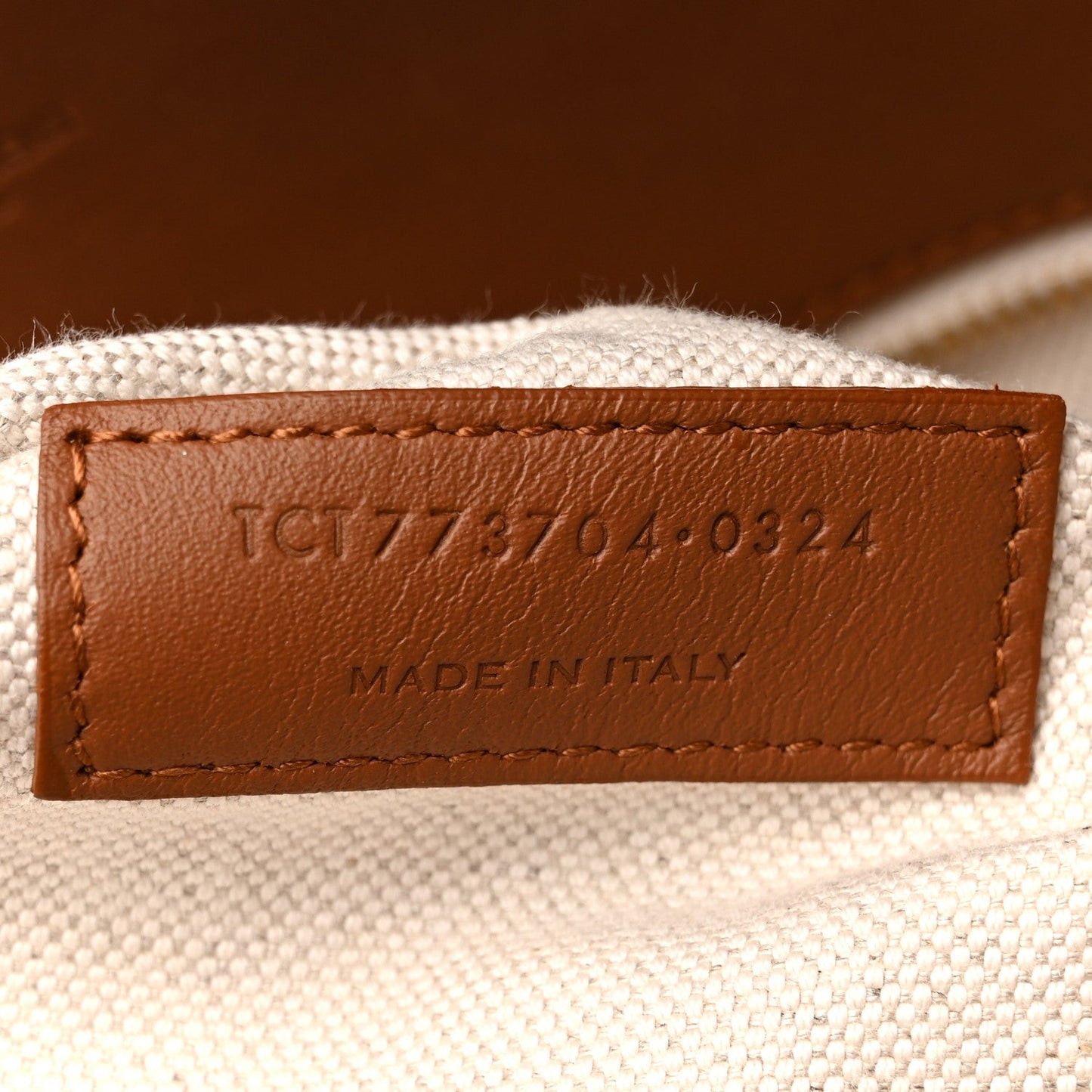 Leather label on canvas tote reading MADE IN ITALY with product code