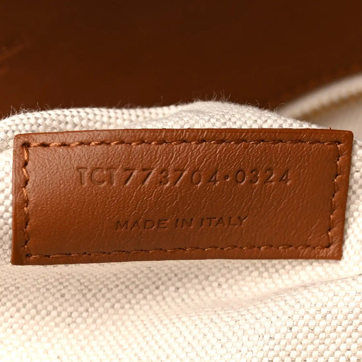 Leather label on canvas tote reading MADE IN ITALY with product code