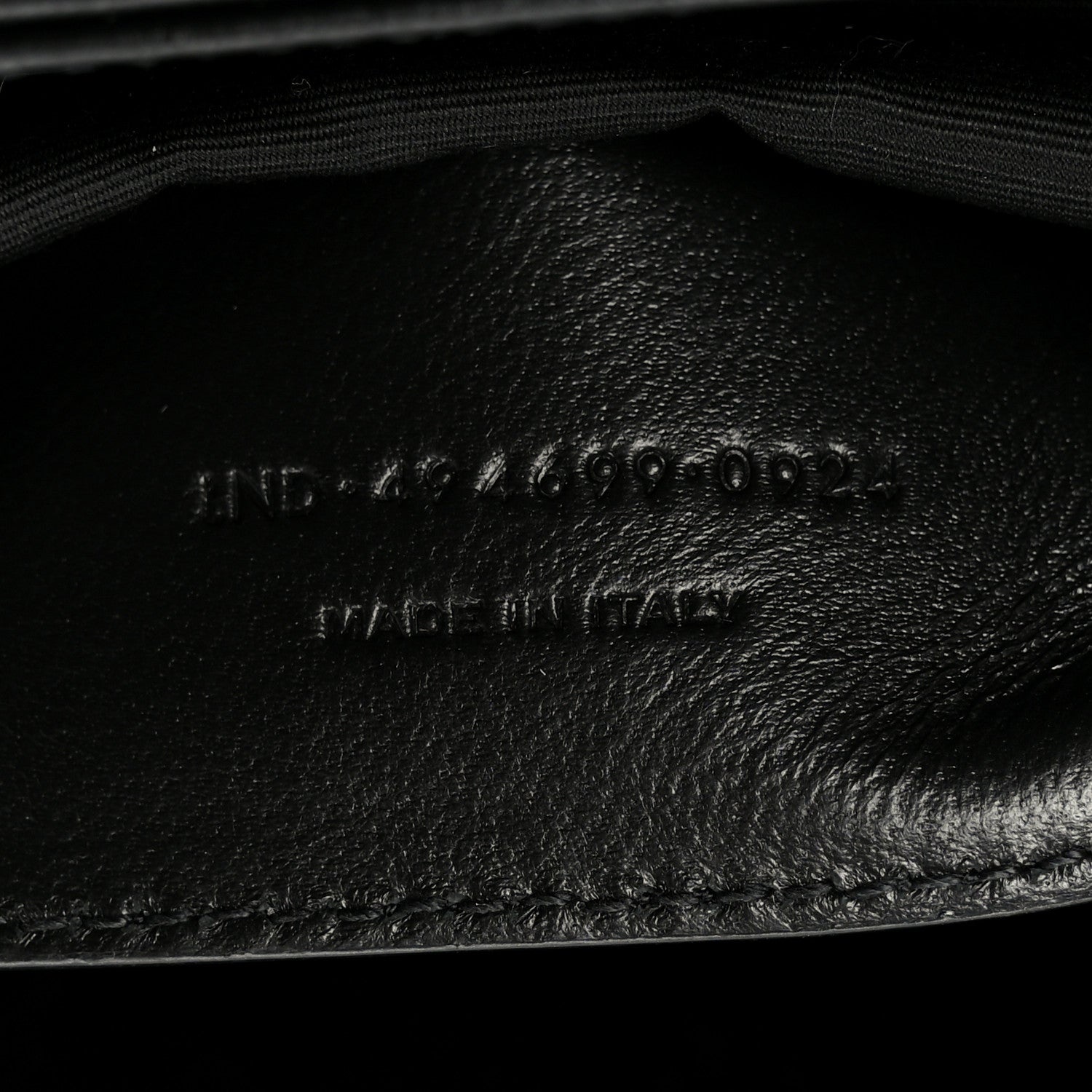 Black leather interior lining with embossed markings and curved seam detail.
