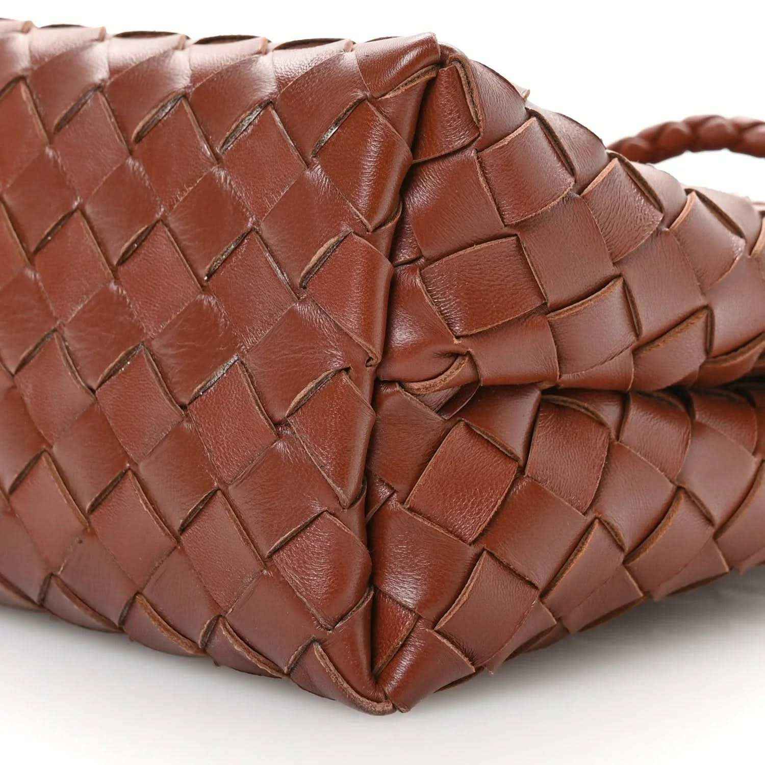 Small leather bag corner close-up in Sapele brown with intrecciato woven pattern