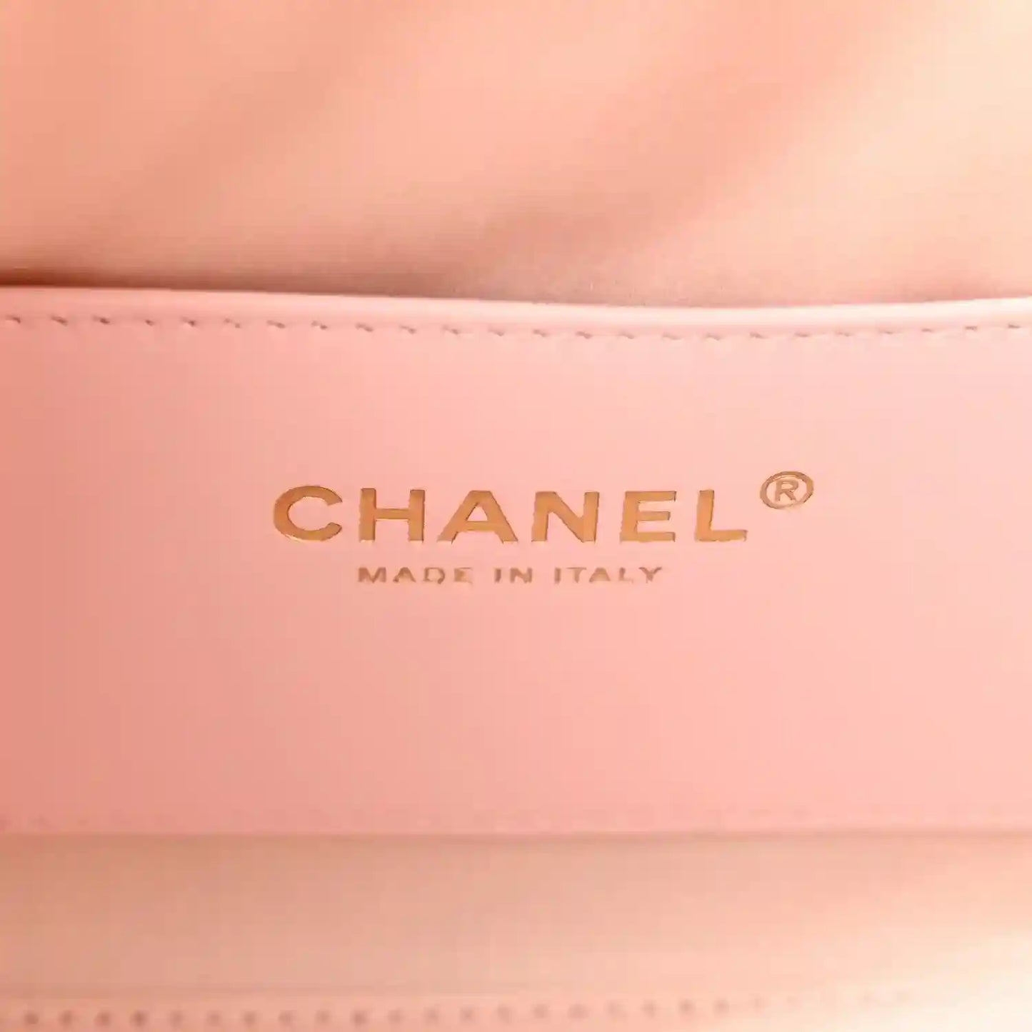 Chanel logo on light pink leather interior of mini 25 handbag