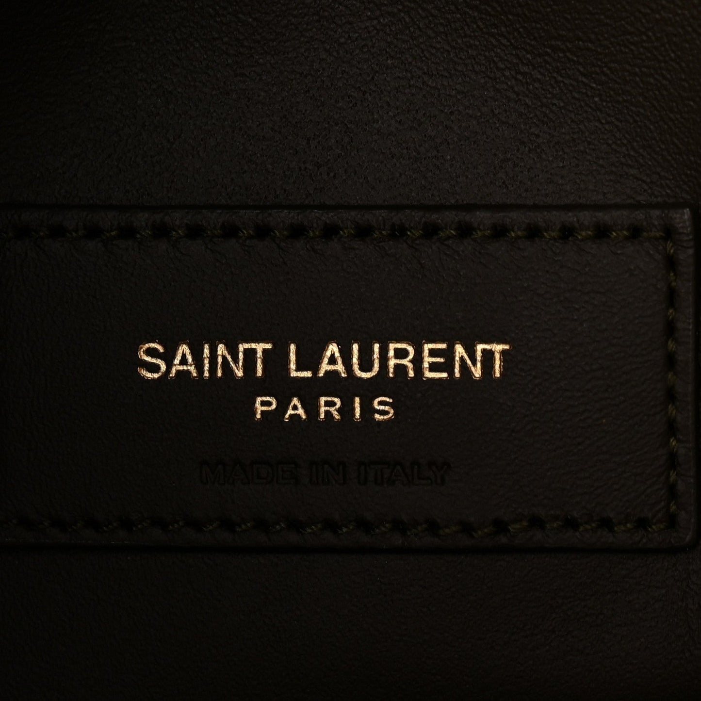 Saint Laurent leather label on hobo bag, black text and stitched edge