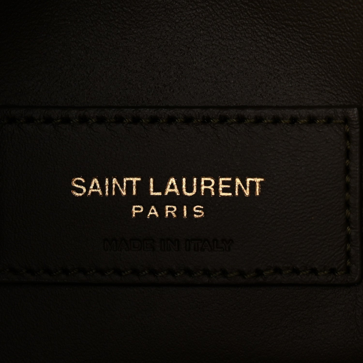 Saint Laurent leather label on hobo bag, black text and stitched edge