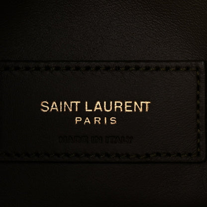 Saint Laurent leather label on hobo bag, black text and stitched edge