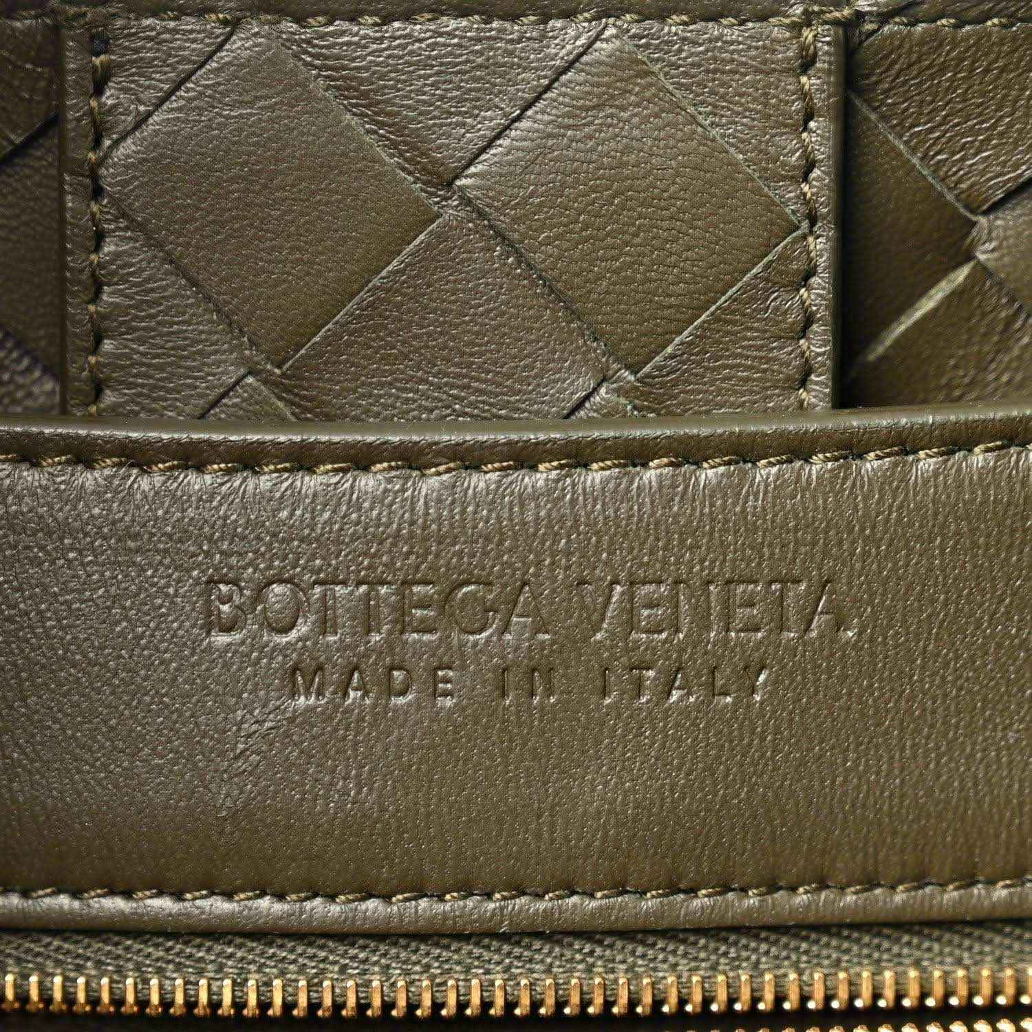 Bottega Veneta leather bag front panel with woven texture and embossed brand mark