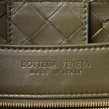Bottega Veneta leather bag front panel with woven texture and embossed brand mark