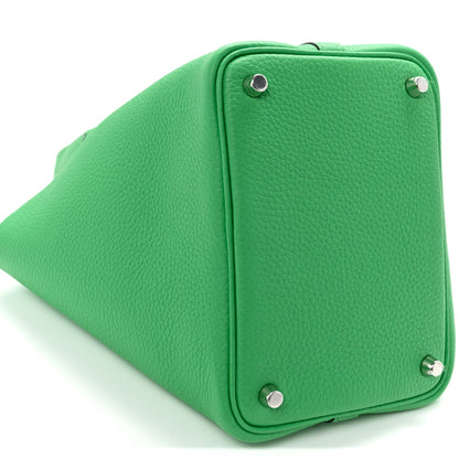 Green leather lock tote bag with corner studs and top frame hardware