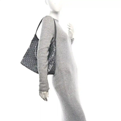 Grey hobo bag with top handle, side profile, and repeating Goyard logo canvas