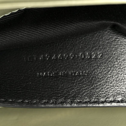 Light sage leather interior base with stamped serial text near zipper opening