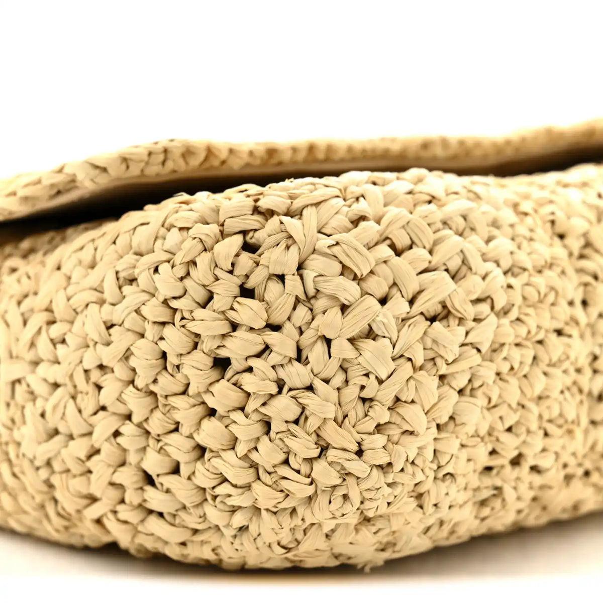 Natural raffia bag exterior close-up with braided woven texture