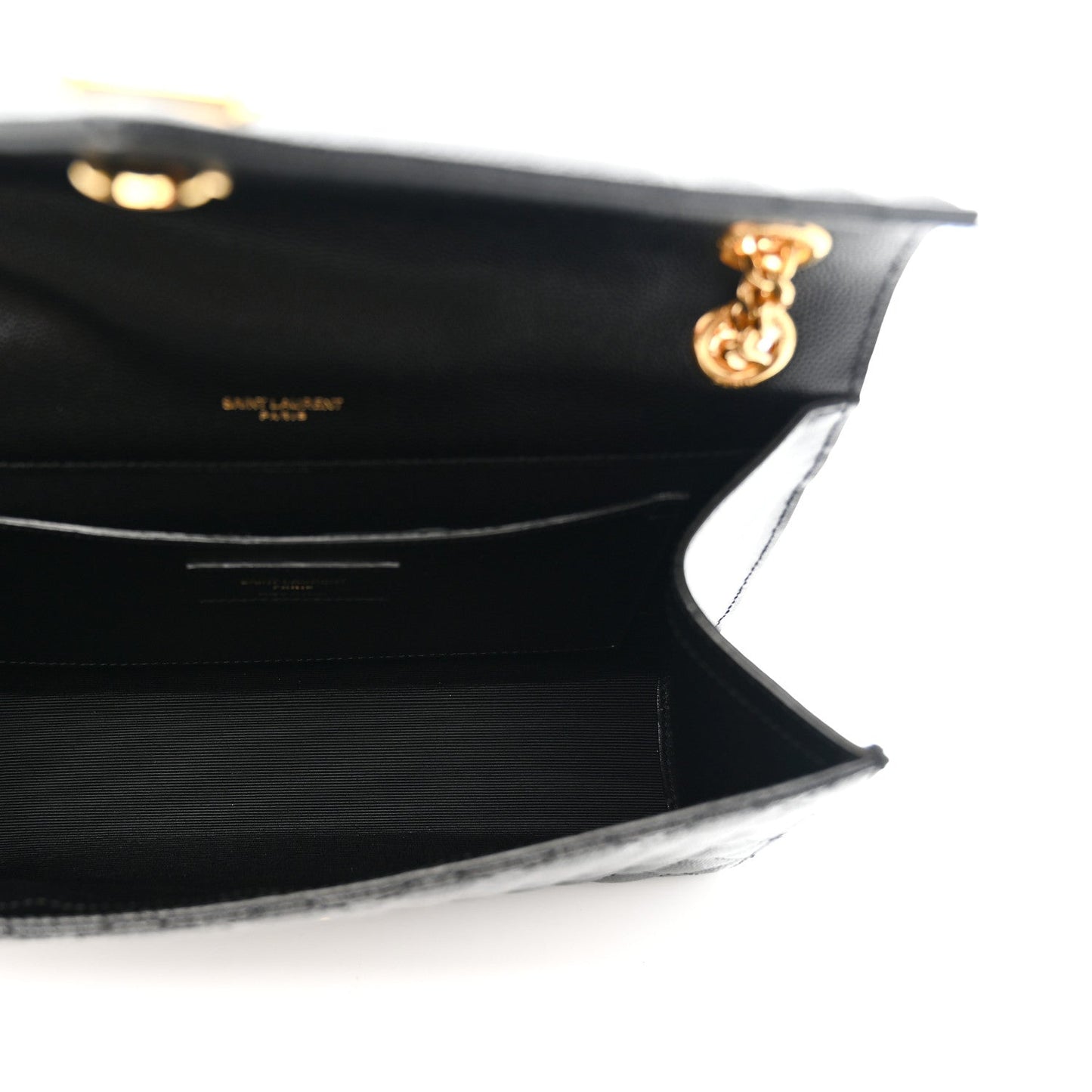 Black satchel interior view with flap hinge and gold chain hardware