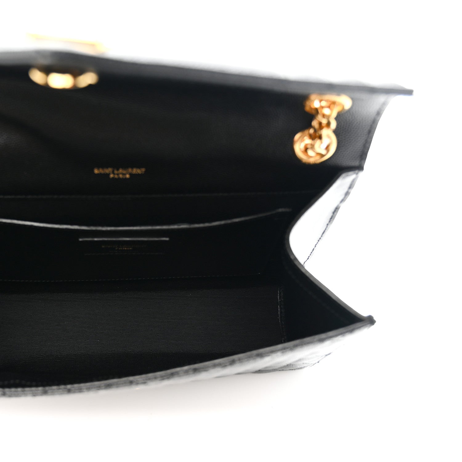 Black satchel interior view with flap hinge and gold chain hardware