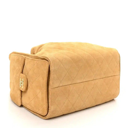Chanel quilted beige suede handbag with front pocket and flap detail; chain strap