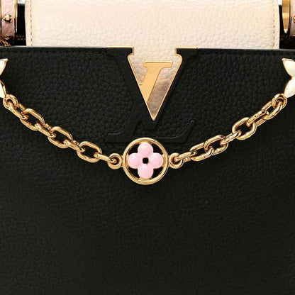 Black and cream leather handbag with gold chain and pink flower logo charm