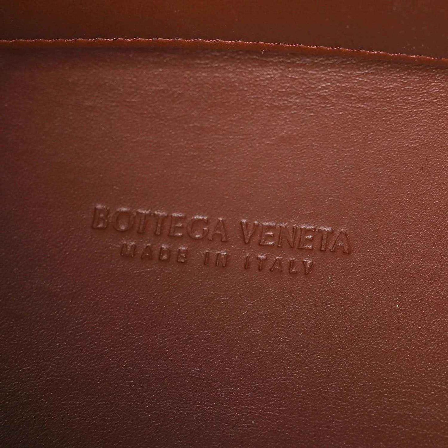 Leather interior panel with raised text branding on brown Nappa lining