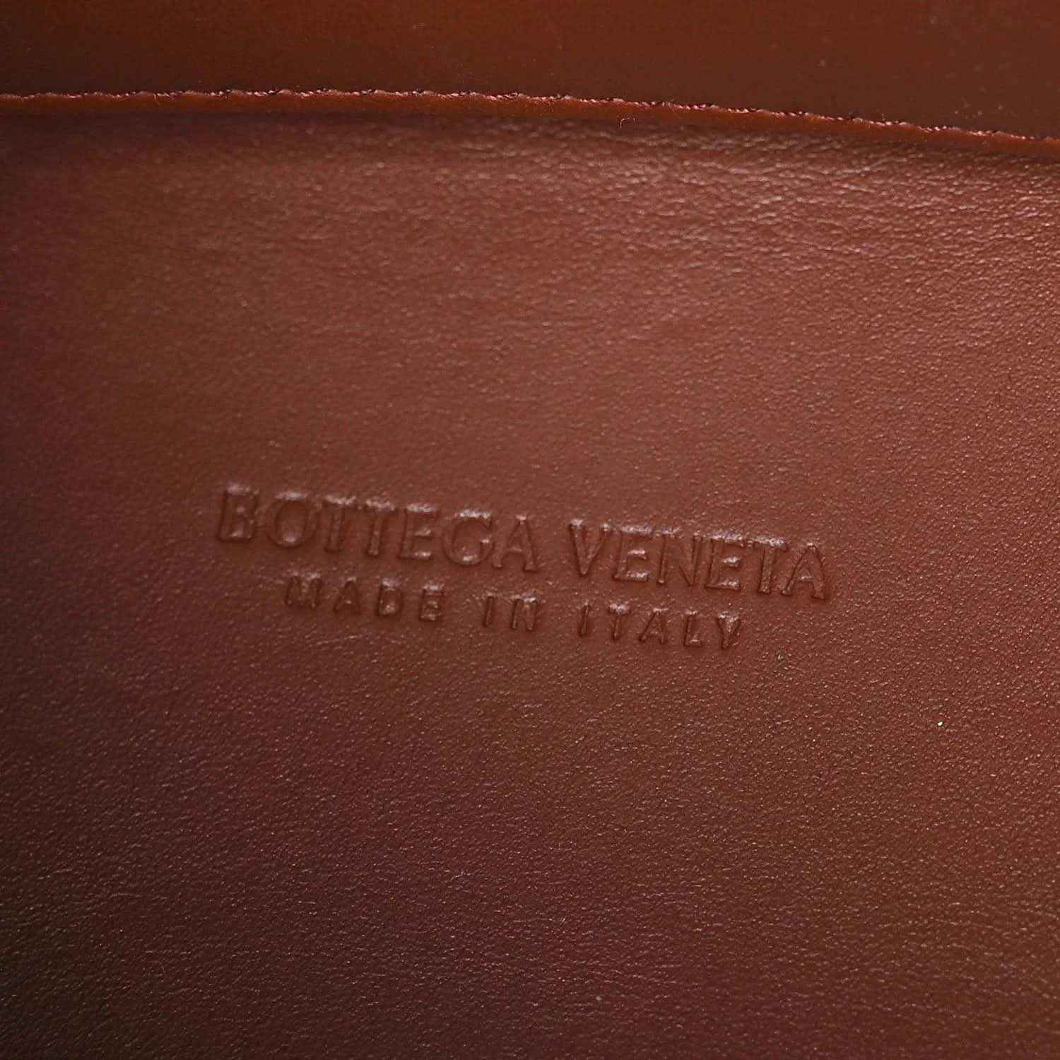 Leather interior panel with raised text branding on brown Nappa lining