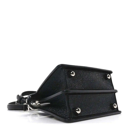 Black leather-trimmed satchel base with hardware studs and adjustable strap