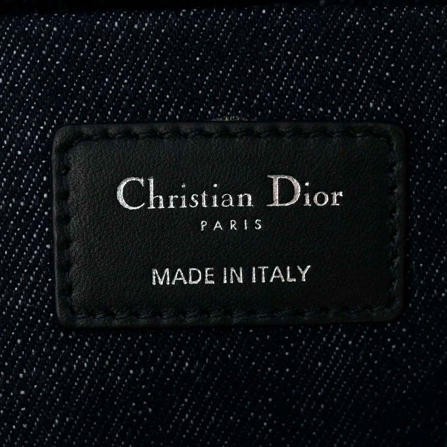 Christian Dior Paris label on dark blue denim handbag interior reading Made in Italy
