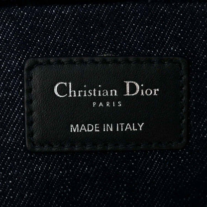 Christian Dior Paris label on dark blue denim handbag interior reading Made in Italy
