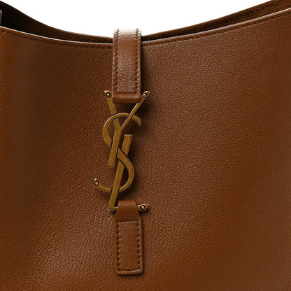 Tan leather hobo bag front with YSL logo hardware and hanging leather tag