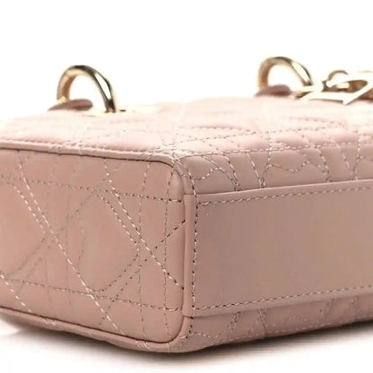 Pale pink quilted lambskin handbag side with structured shape and handle loops