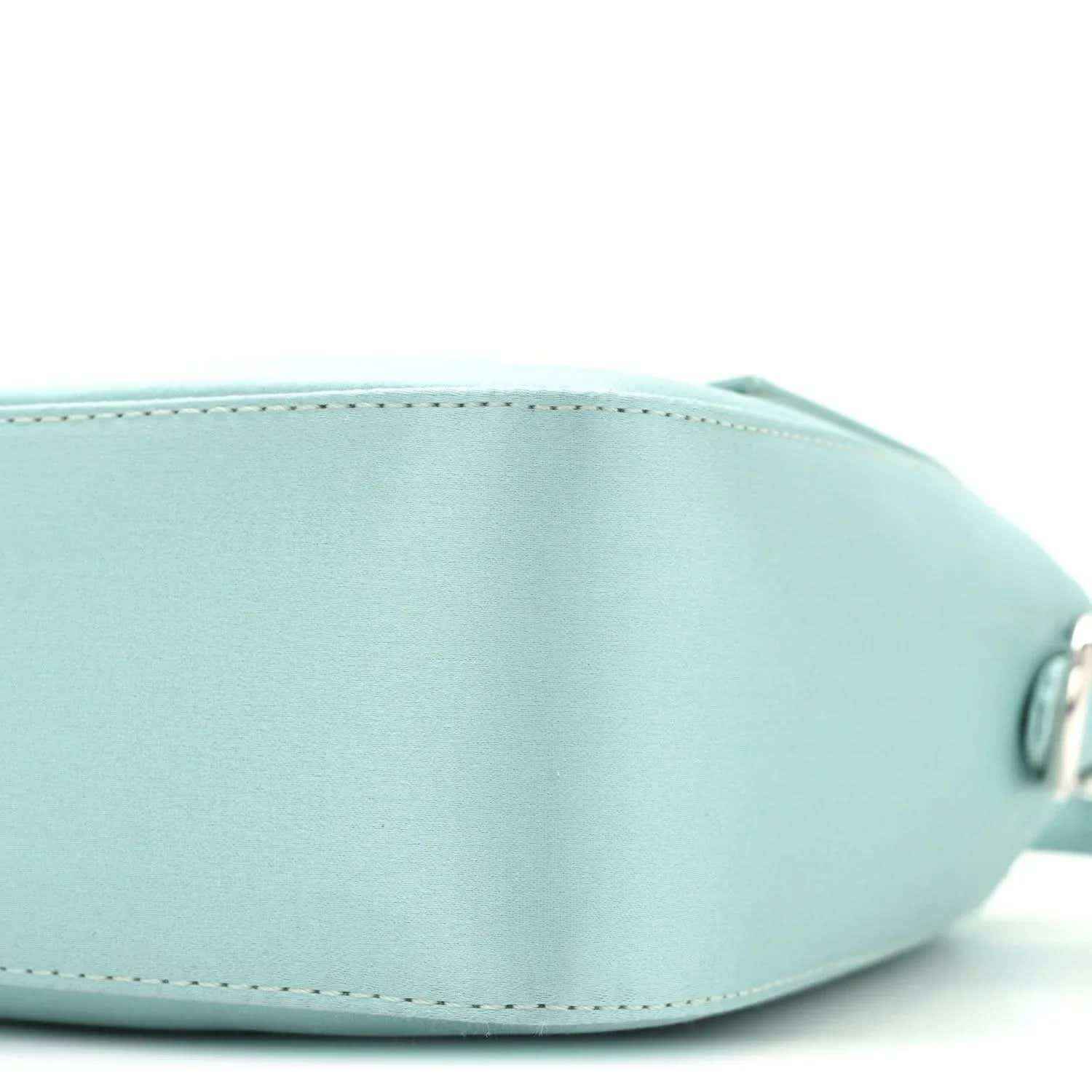 Light blue satin nappa baguette bag, rounded end detail and stitching