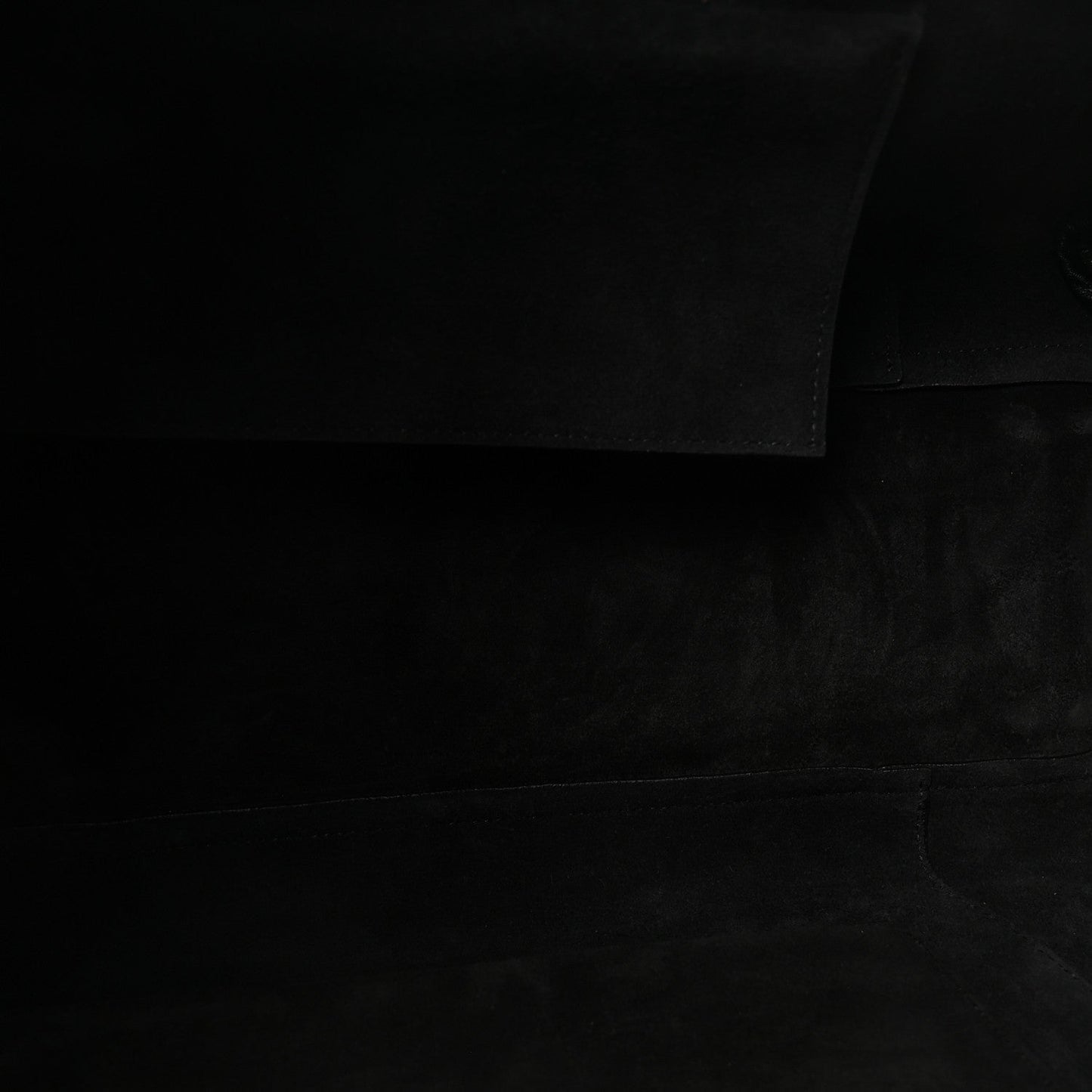 Black leather bag interior lining fabric panel.
