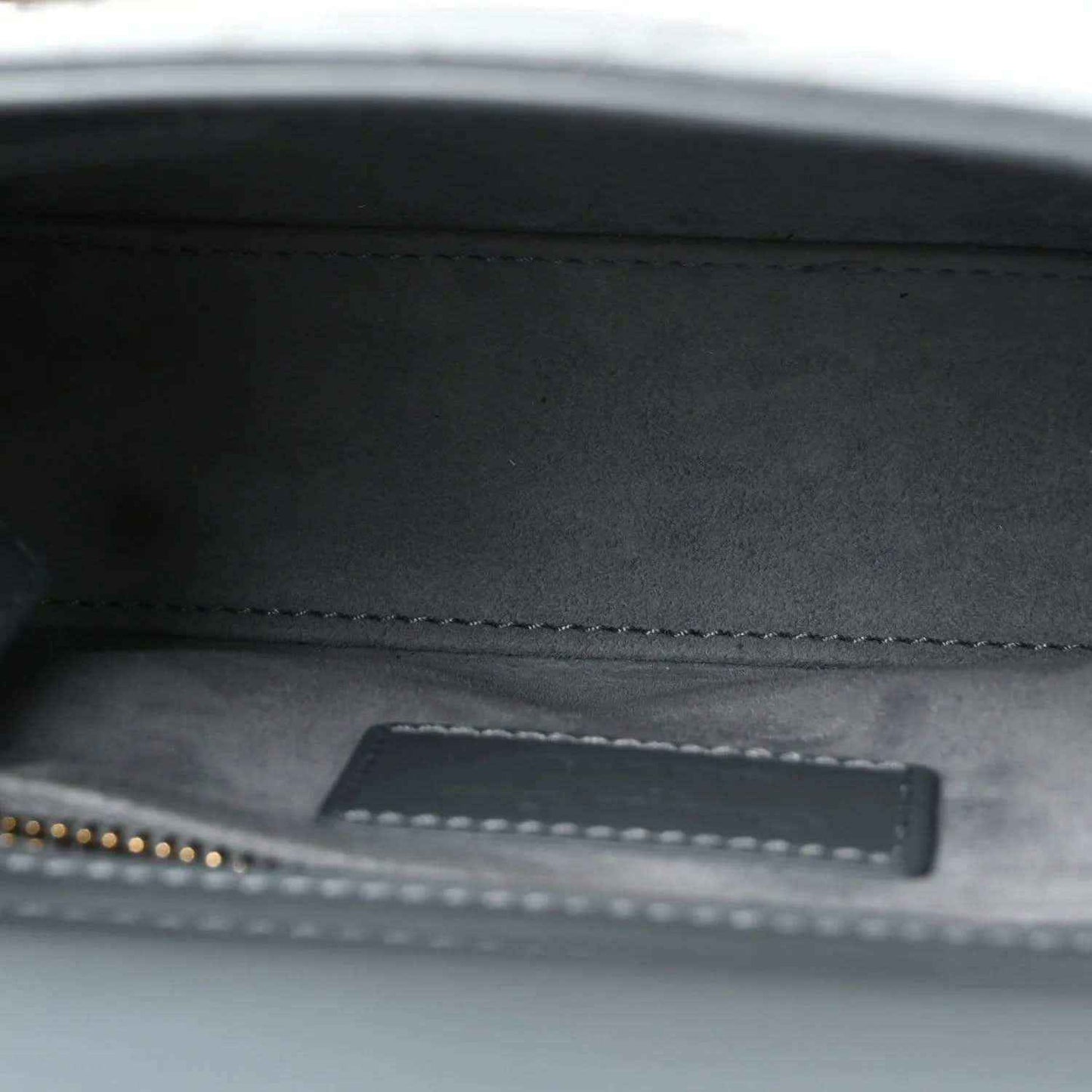 Interior view of light blue mini Lady Dior bag lining with stitched zipper pocket