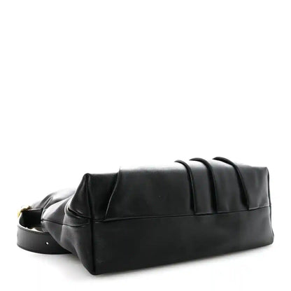 Black leather tote bag with structured base and top seam detail