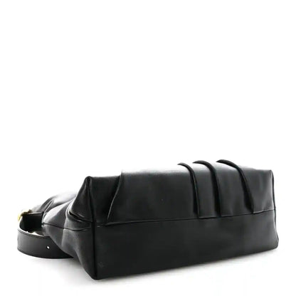 Black leather tote bag with structured base and top seam detail