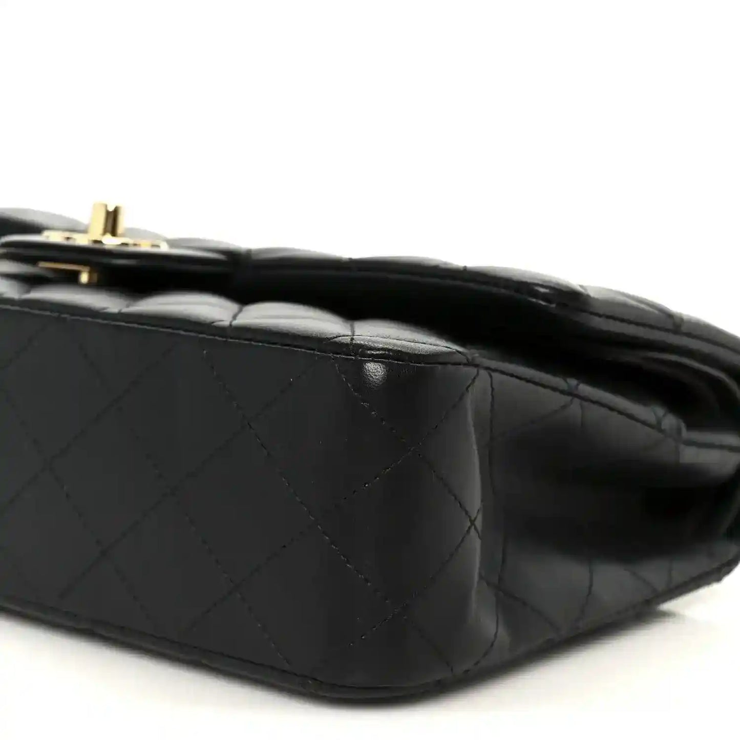 Black quilted lambskin shoulder bag, close-up of diamond stitching and flap edge