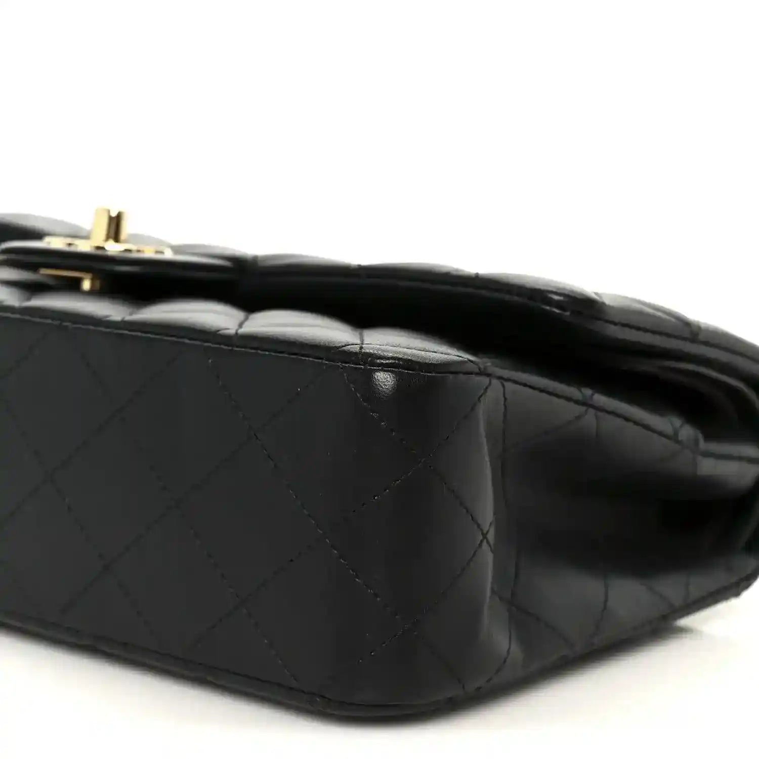 Black quilted lambskin shoulder bag, close-up of diamond stitching and flap edge