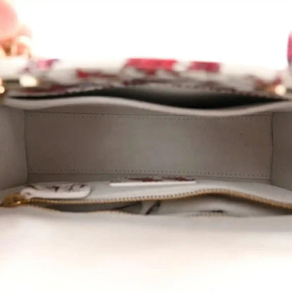 Handbag interior with light lining and zipper track, showing an inner zip pocket