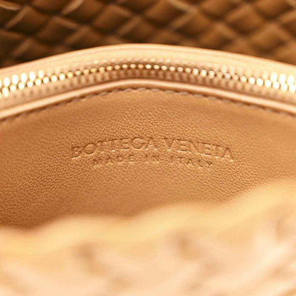 Caramel leather bag interior with stamped logo and gold-tone zipper edge